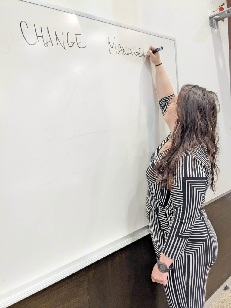 Training Wendy writing change management on a whiteboard